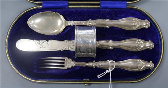 A Victorian cased silver christening trio, together with a later silver napkin ring.